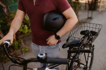 Close up of black helmet, man and bike