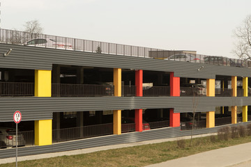 Fototapeta premium modern multi-colored two-level parking lot for cars near a new residential building.