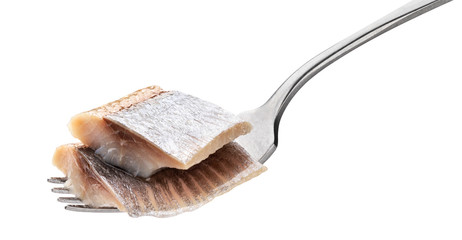 Pieces of salted herring on fork isolated on white background