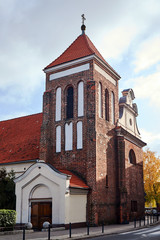 Obraz premium Gothic parish church with belfry in Gniezno.