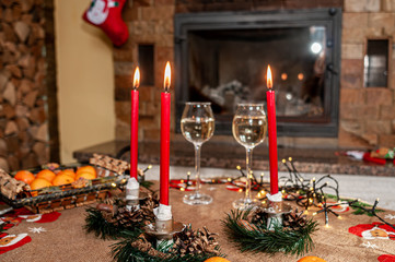 Three red fire candles and pair champagne glasses