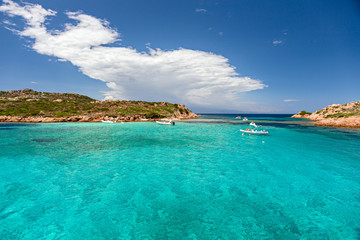 Panoramic view of the pink granite rock formations and the clear and transparent waters in the Maddalena archipelago in Sardinia, Italy.
