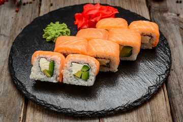 salmon sushi rolls on a stone board