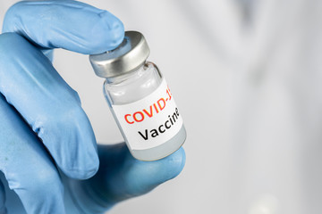 Doctor or nurse hand holding coronavirus vaccine, covid-19 medicine for people immunization, health...