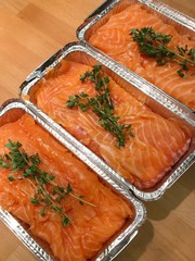 Stages of cooking oven-baked salmon fillet in aluminum form