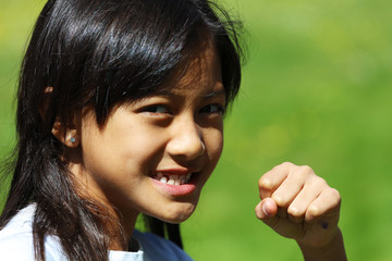 An asian girl smiles and prepares to fight