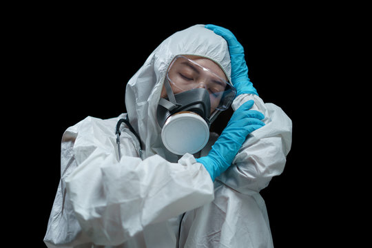 Doctor Wearing Hazmat Suits, Respirator Mask, Safety Glasses And Medical Gloves Make A Rest In The Laboratory.