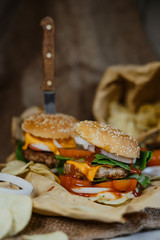 Street food, fast food. Homemade juicy burgers with beef, cheese and caramelized onions