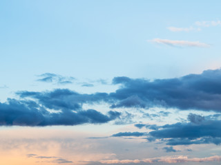 Obraz premium dark clouds in blue sky at spring sunset
