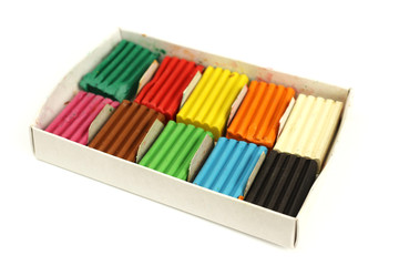 Naklejka premium Set of colorful plasticine in a cardboard box, isolated on whi