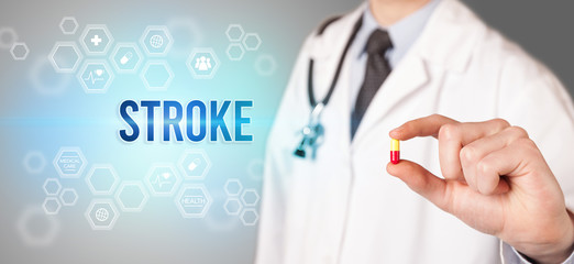 Close-up of a doctor giving you a pill with STROKE inscription, medical concept