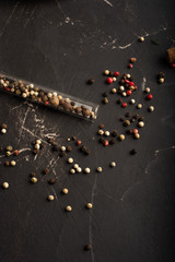 Scattered colorful pepper corns on a kitchen table. Top view