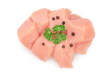 Fresh diced chicken fillet with parsley isolated on white background with clipping path and full depth of field. Top view. Flat lay