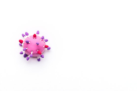 Abstarct virus model of the coronavirus 2019-nCoV  made of air colored children's pink and purple plasticine on the white background.World coronavirus pandemic concept.Copy space for text