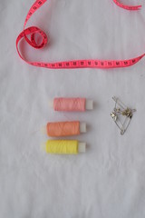 A set of sewing accessories on a white background.