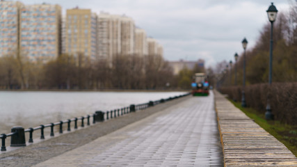 Fototapeta premium Municipal city service cleans city street. Sweeper machine (car) in the working process of cleaning the street. Street cleaning.