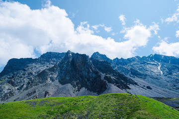 Fototapeta premium mountain valley under cloudy sky, rock ridge on horizon, hiking in mountains, rest and meditation in nature