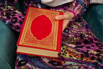 Woman hand holding Quran book