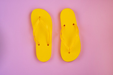 Trendy sunlight Summer composition. Beach flip-flops on a pink background. Minimal summer concept.
