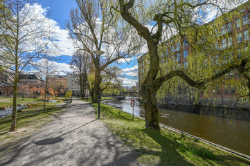Waterfront park Stromparken along Motala river during spring in Norrkoping. Norrkoping is a historic industrial town in Sweden.
