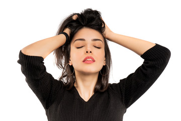 Brunette girl holding her black hair isolated on white background. Portrait of beauty girl.