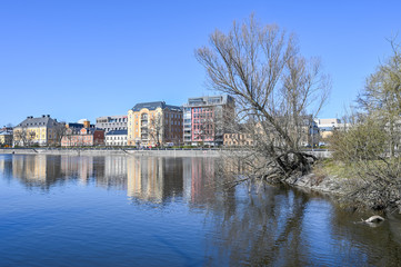 Fototapeta na wymiar Norrkoping waterfront Saltangen and Motala stream on a sunny spring day in Aril 2020. Norrkoping is a historic industrial town in Sweden.