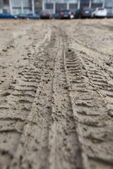 Traces of tires from a car on a dirt road