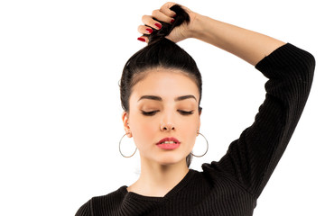 Fototapeta premium Brunette girl holding her black hair isolated on white background. Portrait of beauty girl.