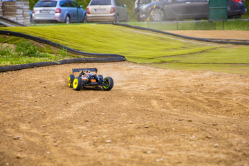 1/8 RC electric buggy drifting through a corner on an offroad track