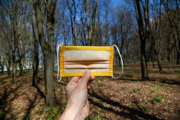 Protective mask against the virus in the spring forest. Coronavirus epidemic.