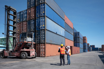 Foreman control loading containers box from cargo freight ship for import export, Foreman control...