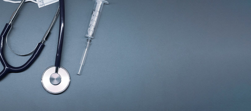 Health care and protection from virus concept, Medical stethoscope or phonendoscope, syringe on greay background.