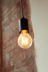  A retro vintage style victorian filament right bulb in a trendy downtown city interior environment. Fashionable addison orange light coffee shop hipster lighting. steampunk inspires lights.