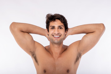 Fototapeta na wymiar Handsome young man with healthy hair. Studio shoot over white background Nude handsome boy