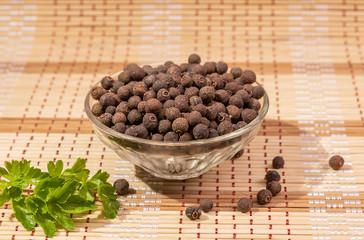 Black pepper peas in a plate and parsley on the table