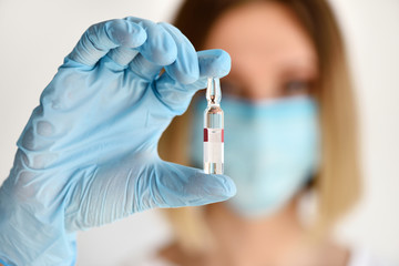 Nurse or doctor holding a ampule of medicine for patient. Vaccination, prevention, immunization and...