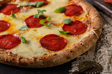 Homemade salami pizza with cheese corners