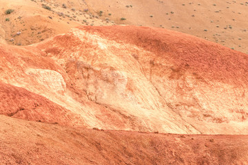 desert landscape on summer day, red hills similar to martian landscape. Soil erosion in canyon, lack of water and rain turns valley into steppe