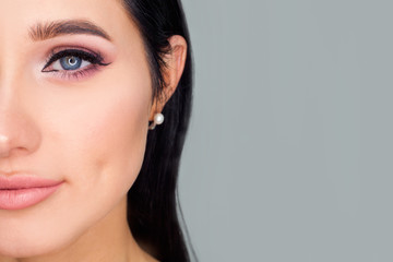 Fototapeta premium Half of the model's face to the left of the text space, close-up eye makeup. A concept photo for advertising cosmetics or makeup artist services.