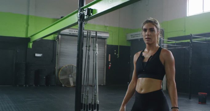 Athletic girl making funny face in gym