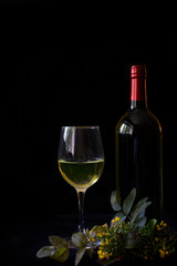 Background for celebrations, wine glasses and wine bottles on a black background
