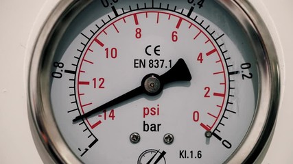 Barometer measuring pressure in industry. We can see the pressure gauge going up and down - close-up view