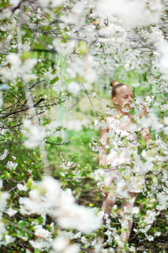Young ballerina in the spring garden