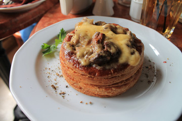 Puff basket with mushrooms in cream sauce and cheese