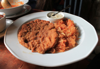 Chop meat with stewed cabbage and sour cream sauce