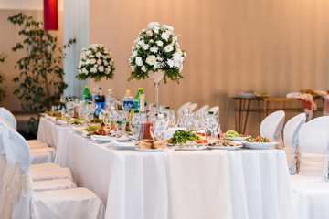 Served banquet decorated table. Wedding decorations in banquet hall. Delicious meal