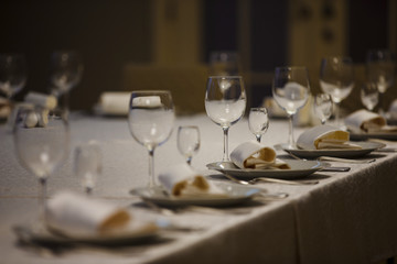 Row of place settings on table for a wedding reception.