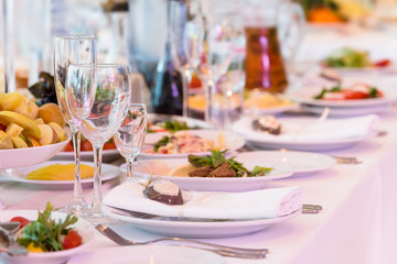 Served banquet decorated table. Wedding decorations in banquet hall. Delicious meal