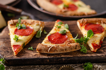 Homemade salami pizza with cheese corners