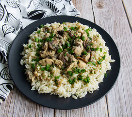 Chicken with mushrooms and rice with greens with cream sauce